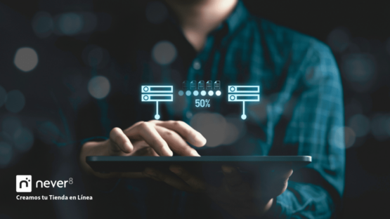 Man using a tablet with server graphics and data transfer, depicting the Adobe Commerce migration process. A specialized ecommerce agency like Never8 can ensure a smooth migration, optimizing the online store to scale and adapt to market demands.
